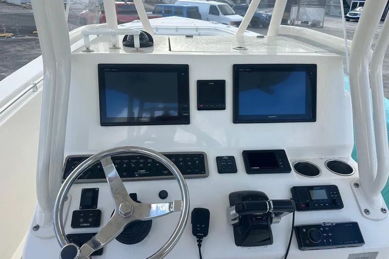 Slide: The Image of 2017 Cobia 296 Center Console boat dashboard with steering wheel and electronic displays. - 38