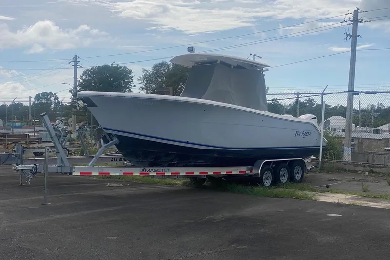 Slide: The Image of 2017 Cobia 296 Center Console boat on trailer in outdoor storage area. - 8