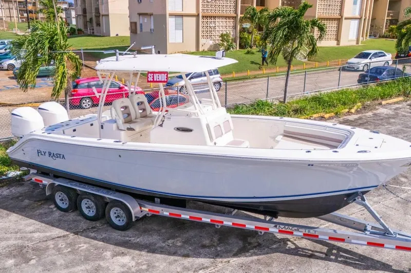 Slide: The Image of 2017 Cobia 296 Center Console boat on trailer, "Fly Rasta," for sale. - 9