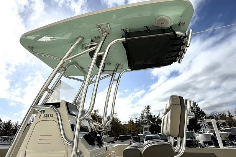 Slide: The Image of 2025 Key West 239 FS boat with T-top and seating, under a partly cloudy sky. - 14