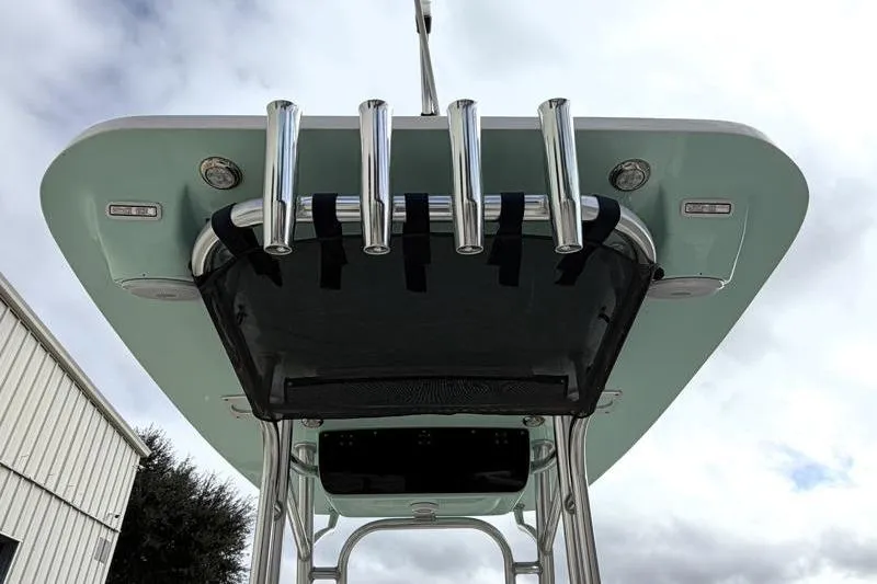 Slide: The Image of 2025 Key West 239 FS boat T-top with rod holders against cloudy sky. - 15