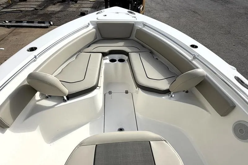 Slide: The Image of 2025 Key West 239 FS boat interior with cushioned seating and cup holders. - 16