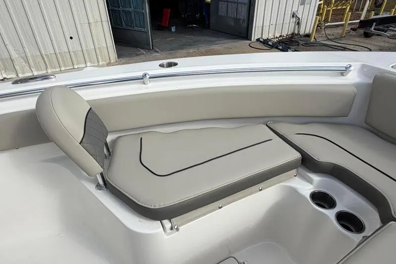 Slide: The Image of 2025 Key West 239 FS boat interior with cushioned seating and cup holders. - 18