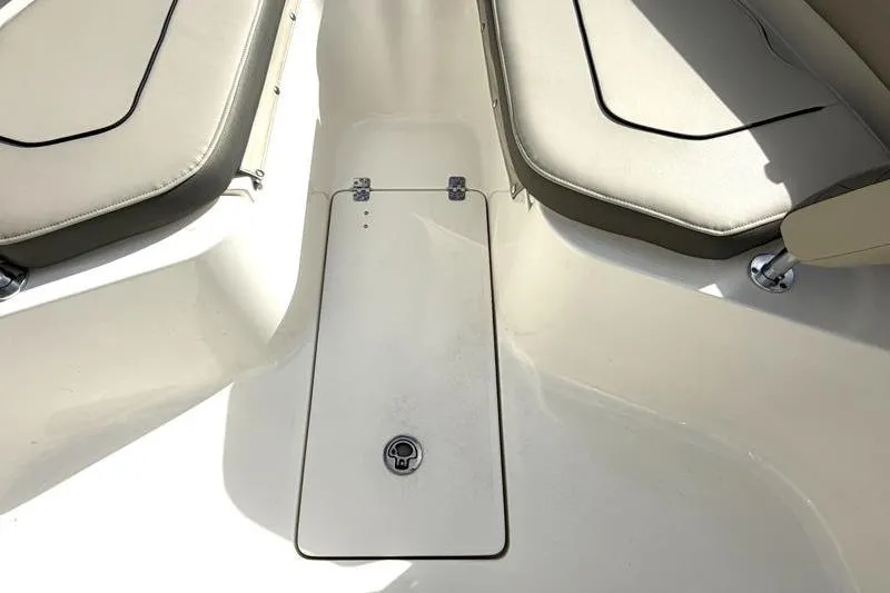 Slide: The Image of 2025 Key West 239 FS boat interior with cushioned seating and storage compartment. - 20