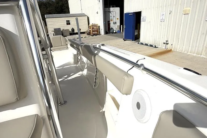 Slide: The Image of 2025 Key West 239 FS boat interior with beige seating and stainless steel railings. - 21