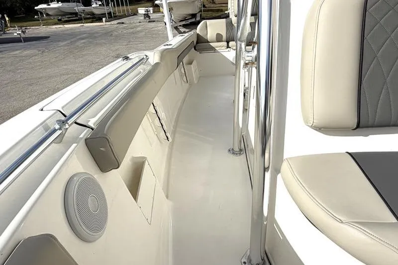 Slide: The Image of 2025 Key West 239 FS boat interior with cushioned seating and speaker system. - 22
