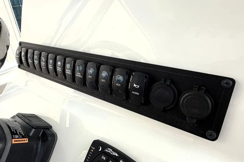 Slide: The Image of Control panel of 2025 Key West 239 FS boat with multiple switches and outlets. - 28