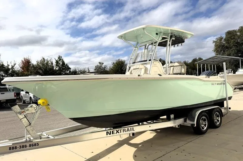 Slide: The Image of 2025 Key West 239 FS boat on trailer under cloudy sky. - 3