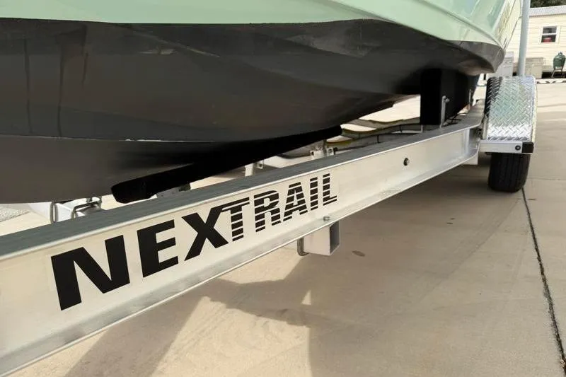 Slide: The Image of 2025 Key West 239 FS boat on NexTrail trailer, parked on concrete surface. - 43
