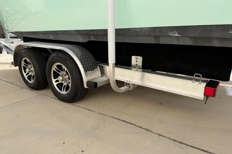 Slide: The Image of 2025 Key West 239 FS boat on a dual-axle trailer, side view. - 45