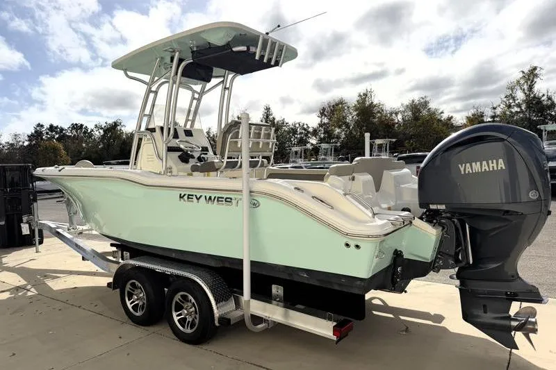 Slide: The Image of 2025 Key West 239 FS boat with Yamaha engine on trailer, parked outdoors. - 5