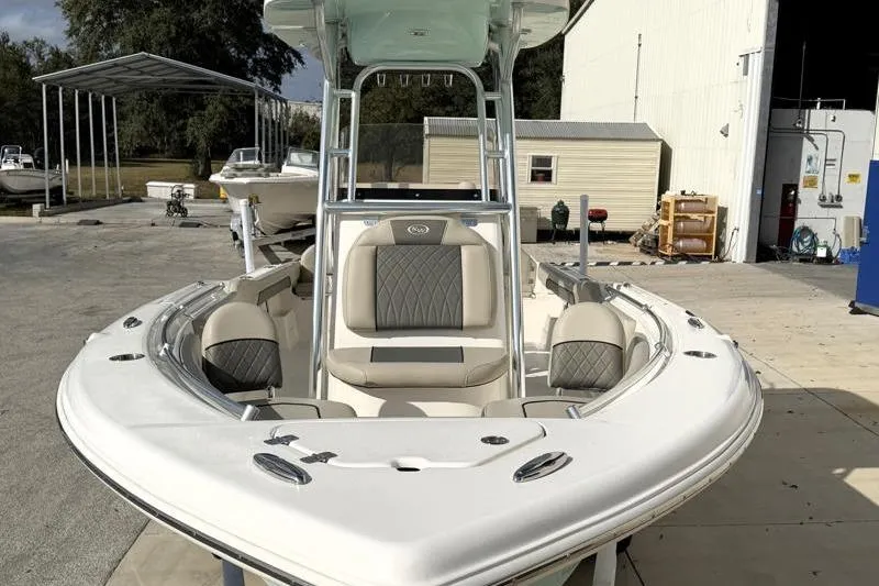 Slide: The Image of 2025 Key West 239 FS boat with sleek design and comfortable seating at a marina. - 6