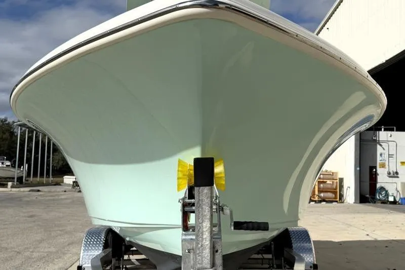 Slide: The Image of 2025 Key West 239 FS boat on trailer, front view, parked outdoors. - 7