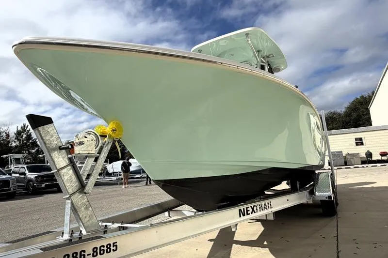 Slide: The Image of 2025 Key West 239 FS boat on trailer under cloudy sky. - 9