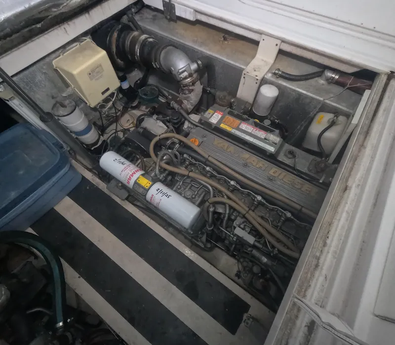 Slide: The Image of Engine compartment of a 2005 Stamas 370 Express boat, showcasing mechanical components. - 19