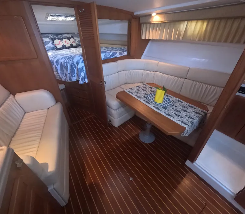 Slide: The Image of 2005 Stamas 370 Express cabin interior with wood flooring, cozy seating, and dining area. - 28