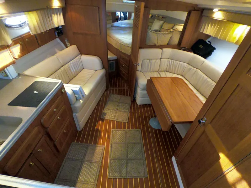 Slide: The Image of Interior of 2005 Stamas 370 Express yacht with cozy seating and wooden finishes. - 29