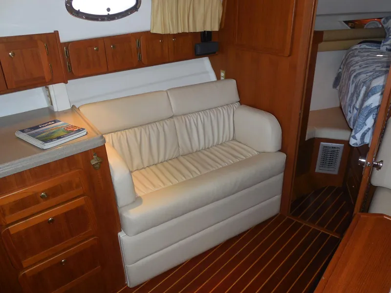 Slide: The Image of 2005 Stamas 370 Express cabin interior with beige sofa and wooden cabinetry. - 32