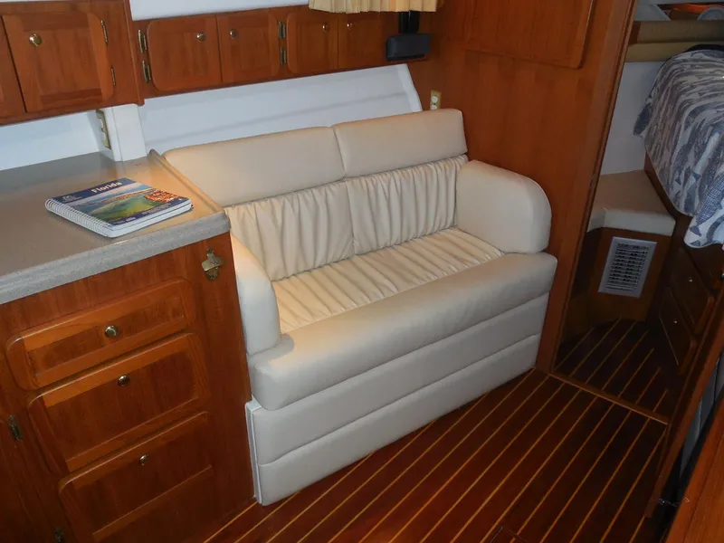 Slide: The Image of Interior of 2005 Stamas 370 Express with white sofa and wooden cabinetry. - 34