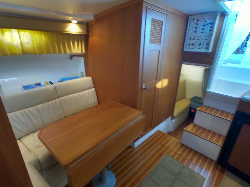 Slide: The Image of 2005 Stamas 370 Express cabin interior with wooden table, seating, and stairs. - 36