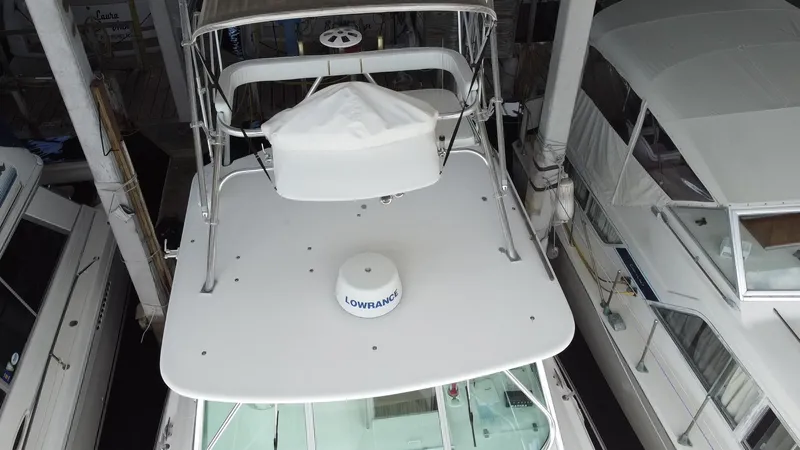 Slide: The Image of 2005 Stamas 370 Express boat with radar equipment, docked among other vessels. - 5