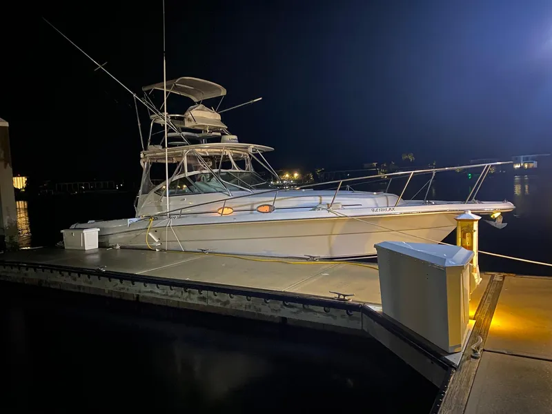 Slide: The Image of 2005 Stamas 370 Express yacht docked at night, illuminated by dock lights. - 6