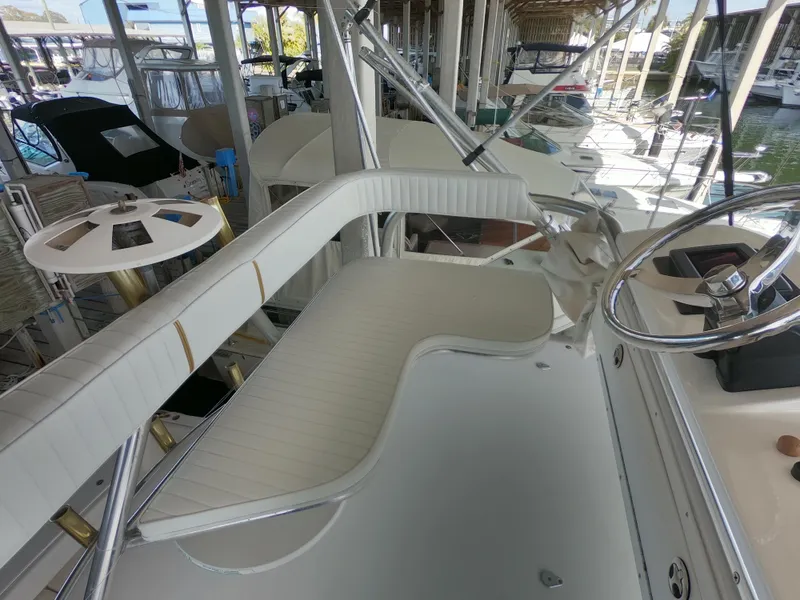 Slide: The Image of 2005 Stamas 370 Express boat interior with white seating and steering wheel. - 7