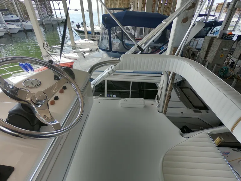 Slide: The Image of 2005 Stamas 370 Express boat helm with docked vessels in background. - 8