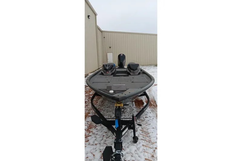 Slide: The Image of 2025 Ranger ALPHA 208 boat on trailer, parked in snowy outdoor setting. - 10