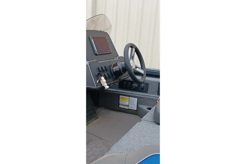 Slide: The Image of Interior view of 2025 Ranger ALPHA 208 boat dashboard with steering wheel and controls. - 19