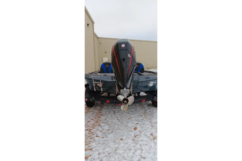 Slide: The Image of 2025 Ranger ALPHA 208 boat with powerful outboard motor on snowy ground. - 23