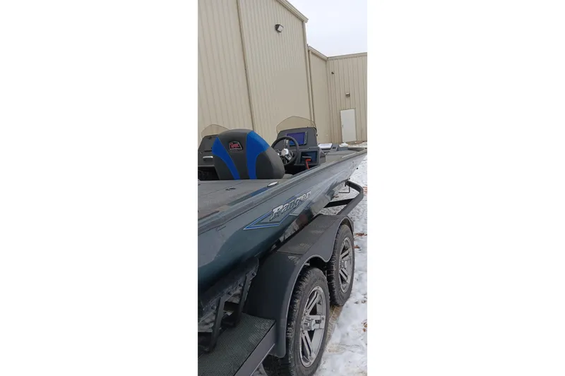Slide: The Image of 2025 Ranger ALPHA 208 boat on trailer, parked outside a beige building in snowy conditions. - 30