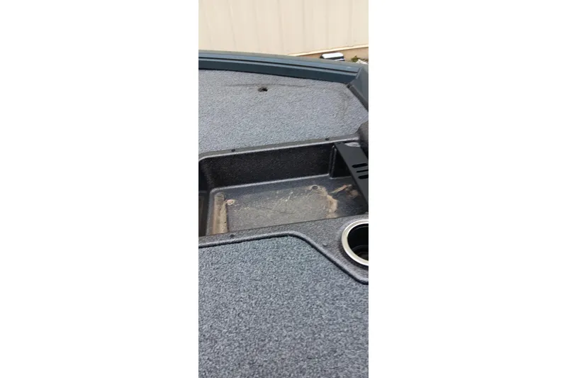 Slide: The Image of Ranger ALPHA 208 boat deck, 2025 model, featuring storage compartment and cup holder. - 7