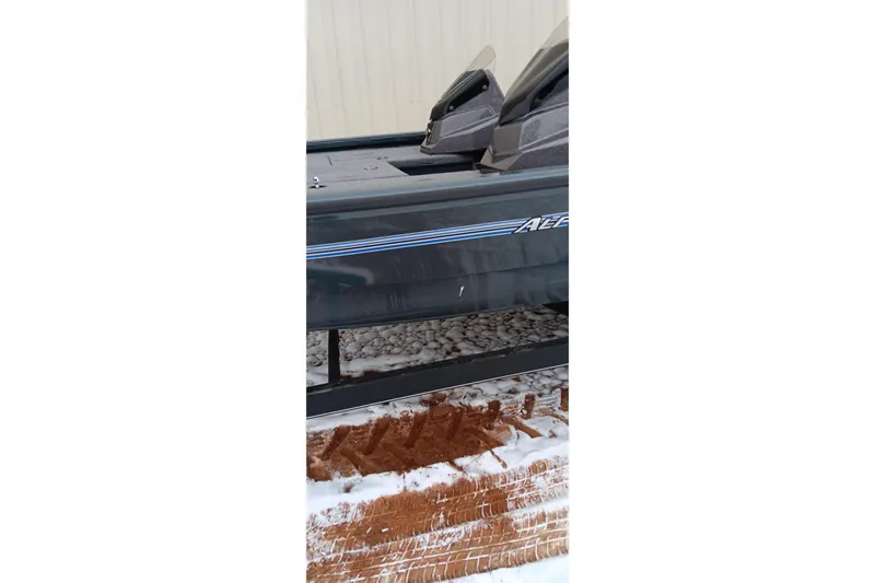 Slide: The Image of 2025 Ranger ALPHA 208 boat on snowy ground, partial side view. - 8