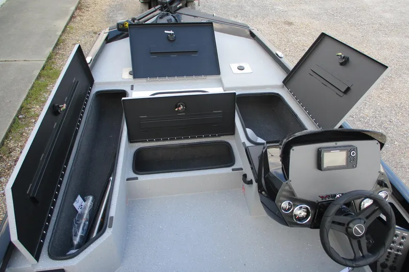 Slide: The Image of 2026 Vexus AVX189 boat interior with open storage compartments and steering console. - 10