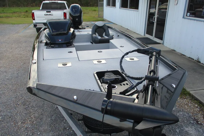 Slide: The Image of 2026 Vexus AVX189 boat with trolling motor, parked near a GMC truck. - 8