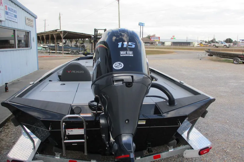Slide: The Image of 2026 Vexus AVX189 boat with Yamaha 115 outboard motor, parked on a trailer. - 3