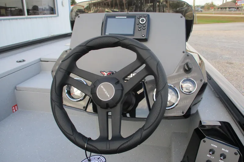 Slide: The Image of 2026 Vexus AVX189 boat dashboard with steering wheel and control panel. - 6