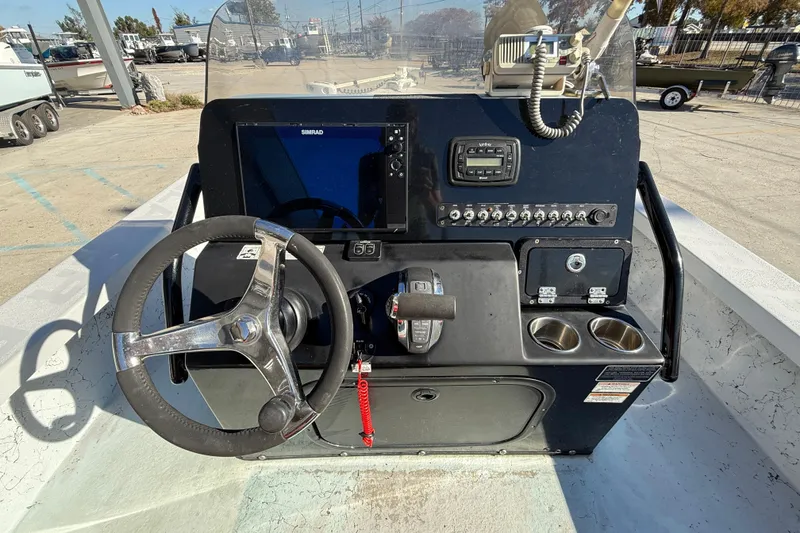 Slide: The Image of 2018 Blazer Bay 2420 GTS boat dashboard with steering wheel and control panel. - 14