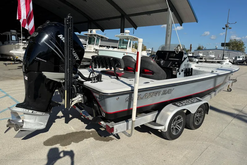 Slide: The Image of 2018 Blazer Bay 2420 GTS boat with Mercury Verado engine on a trailer. - 7