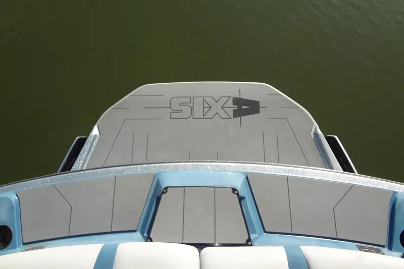 Slide: The Image of 2021 Axis A24 boat swim platform with logo, viewed from above on calm water. - 12