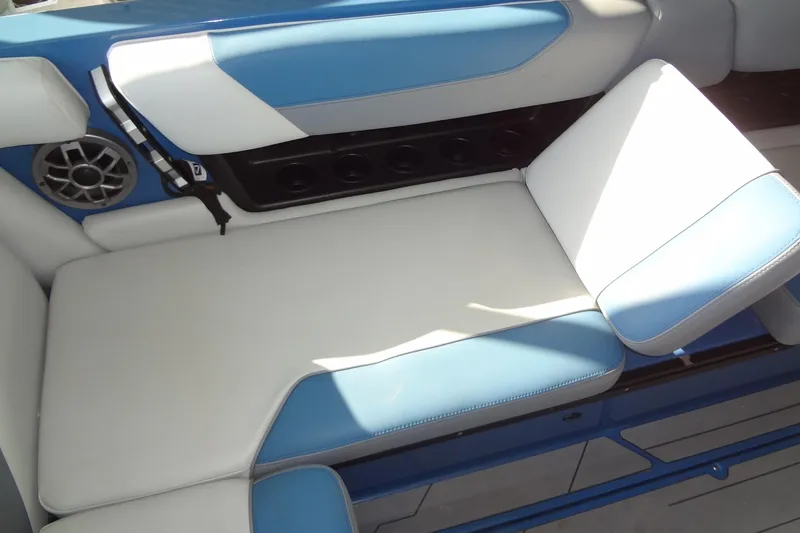 Slide: The Image of 2021 Axis A24 boat interior with blue and white seating and speaker system. - 17