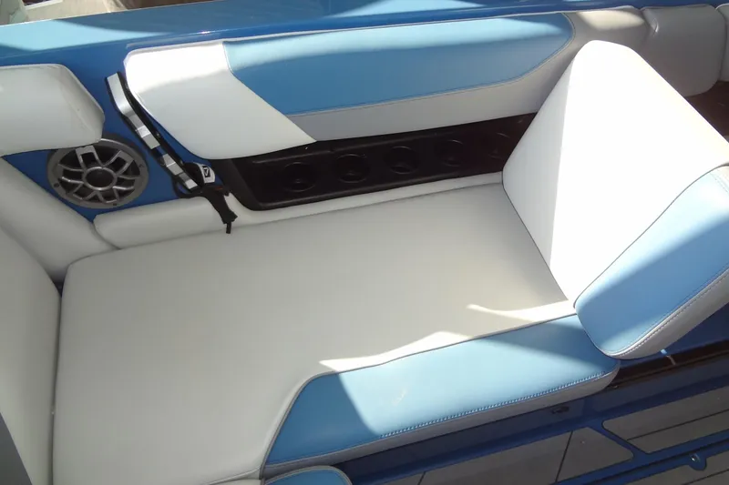 Slide: The Image of 2021 Axis A24 boat interior with blue and white seating and speaker. - 18