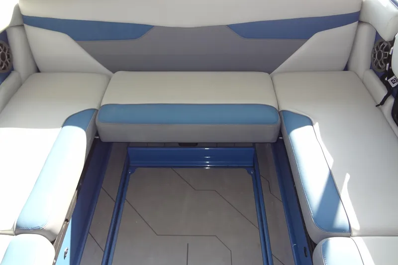 Slide: The Image of 2021 Axis A24 boat interior with blue and white seating and storage compartment. - 19