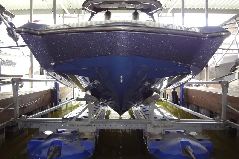 Slide: The Image of 2021 Axis A24 boat in dry dock, showcasing sleek blue hull design. - 3