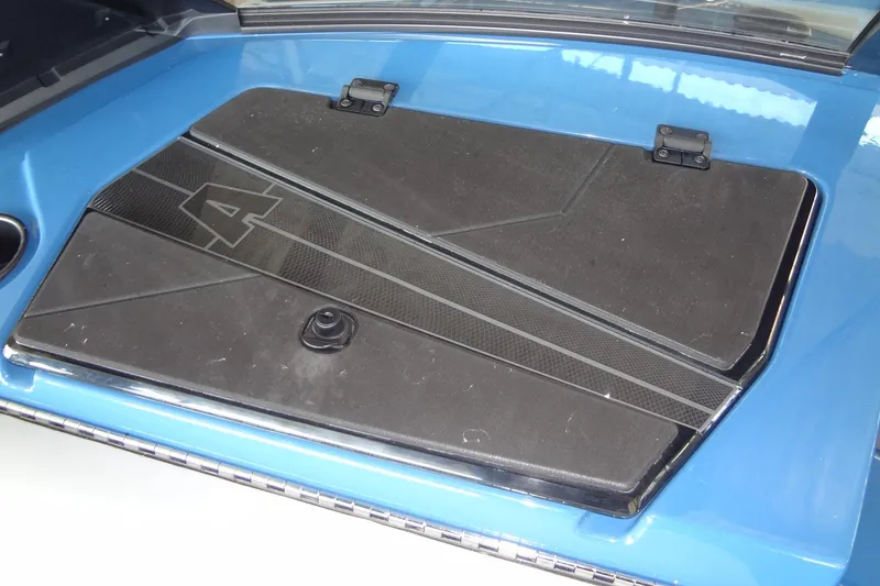 Slide: The Image of 2021 Axis A24 boat engine cover with sleek black and blue design. - 38