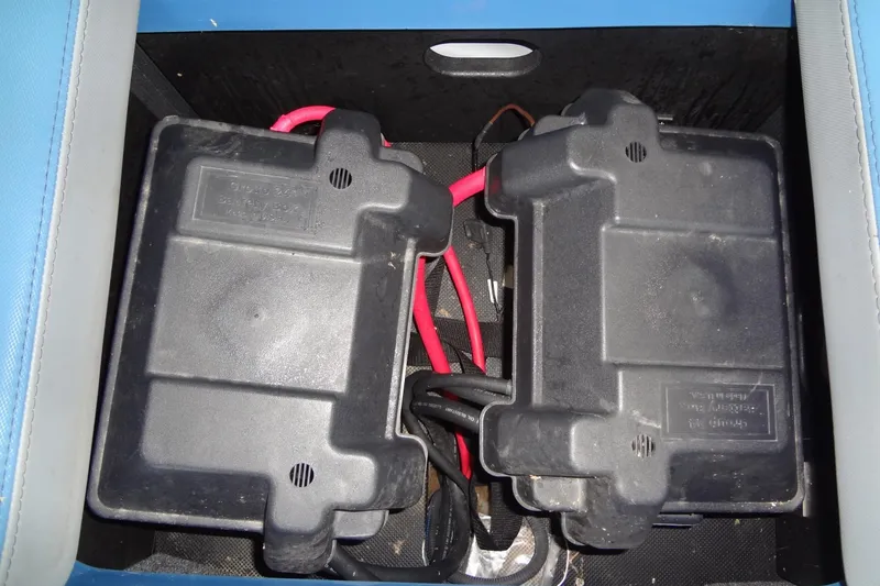 Slide: The Image of Battery compartment of a 2021 Axis A24 boat with red and black cables. - 40