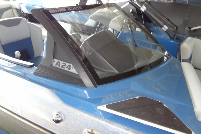 Slide: The Image of 2021 Axis A24 boat with blue exterior and sleek windshield design. - 45