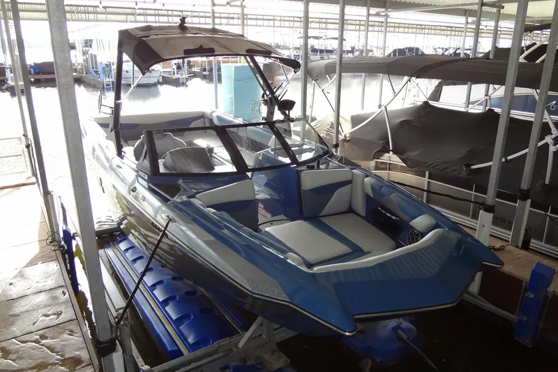 Slide: The Image of 2021 Axis A24 boat in dock, featuring sleek blue and white design. - 5