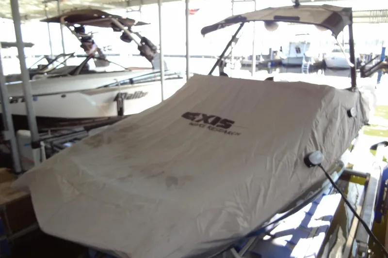 Slide: The Image of 2021 Axis A24 boat covered in a dock, with nearby boats visible. - 50